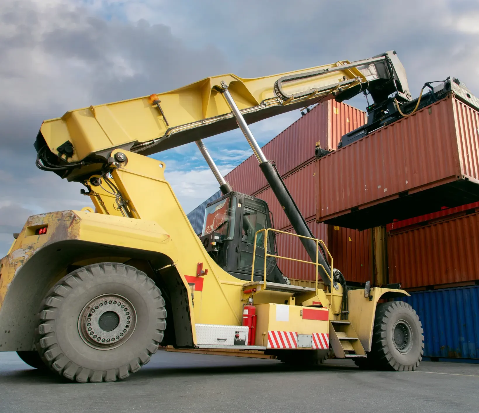 Industrial tractor with industrial wheel system loading containers at a port - WSD Wheel Systems